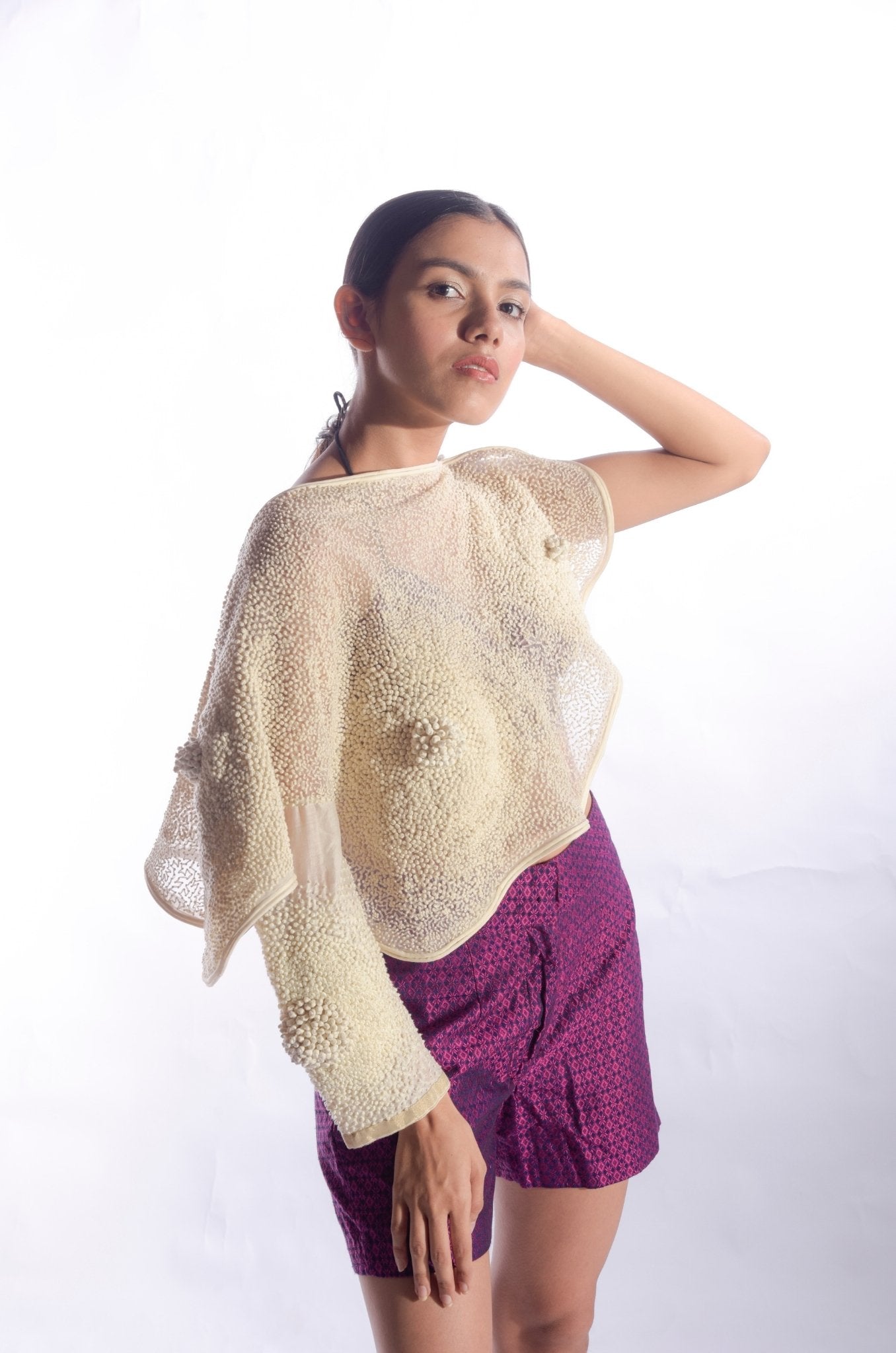 Cape adorned with french knots