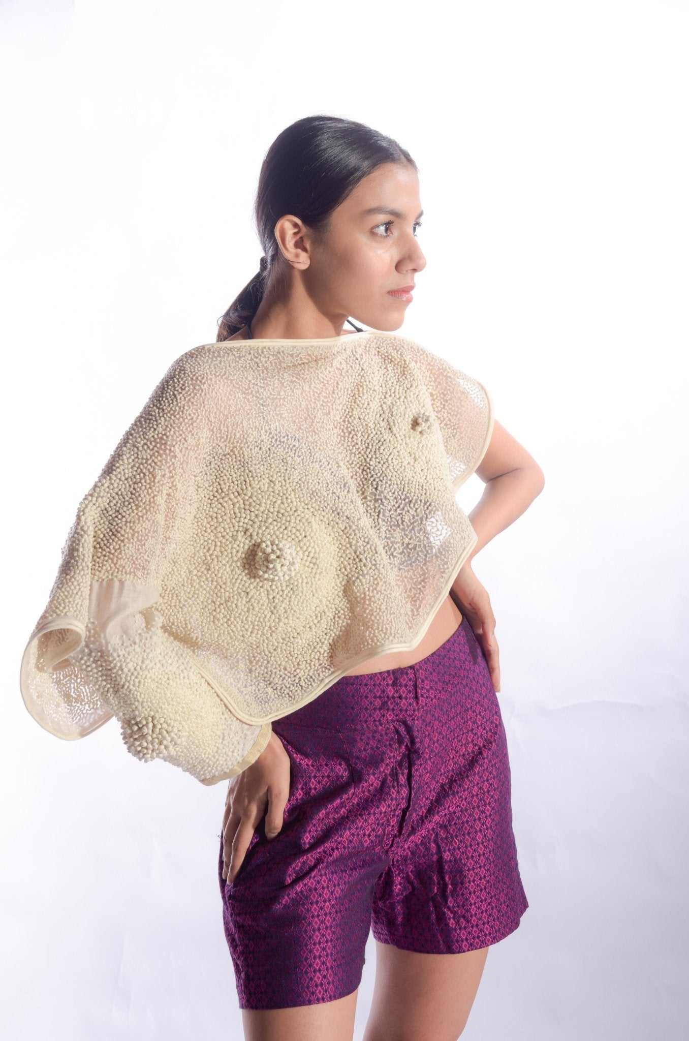 Cape adorned with french knots